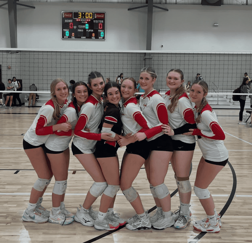 Alabama Juniors Volleyball Club players posing together on an indoor volleyball court